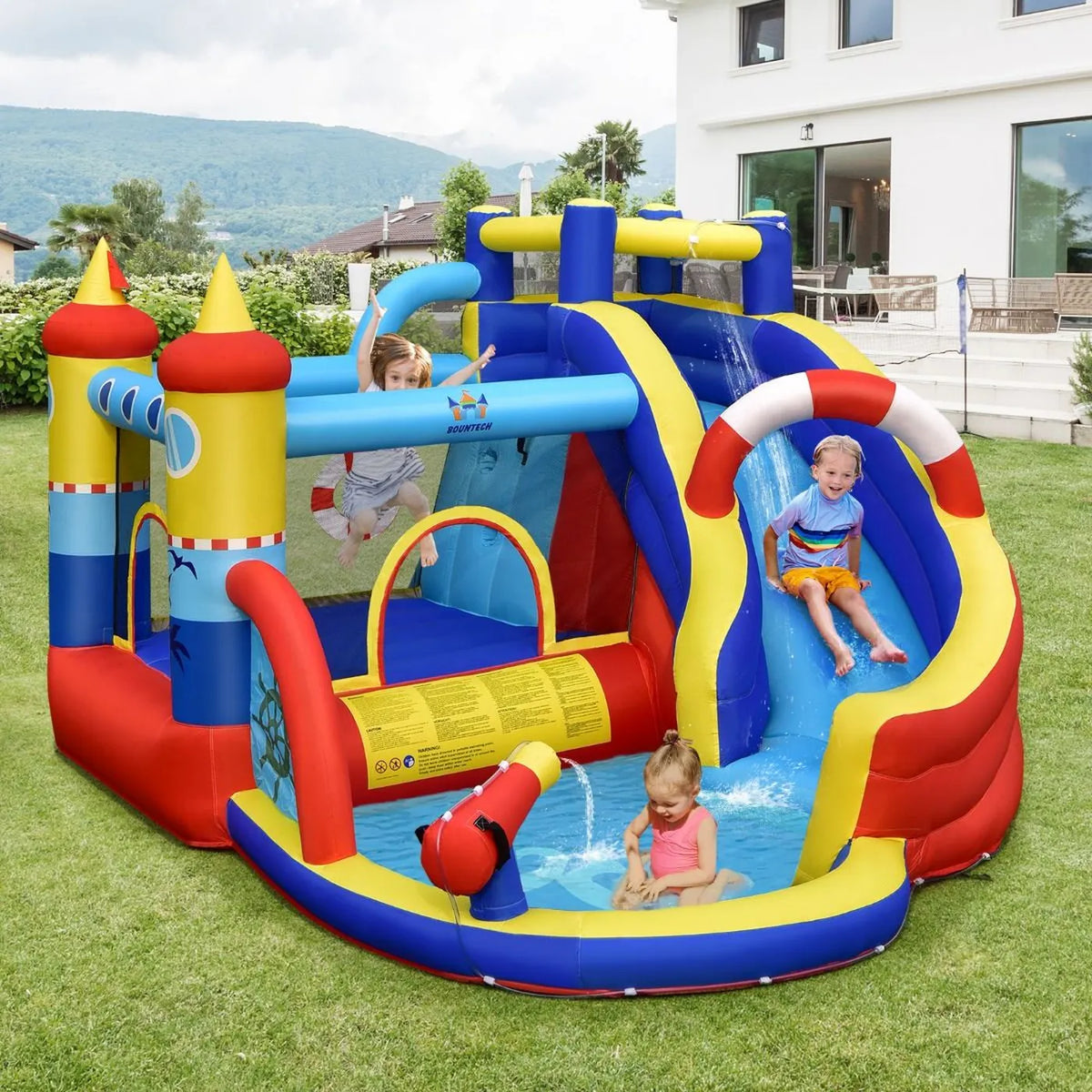 Château gonflable Costway avec soufflerie de 550 W, parc aquatique 6 en 1, comprenant un toboggan, une piscine et un canon à eau